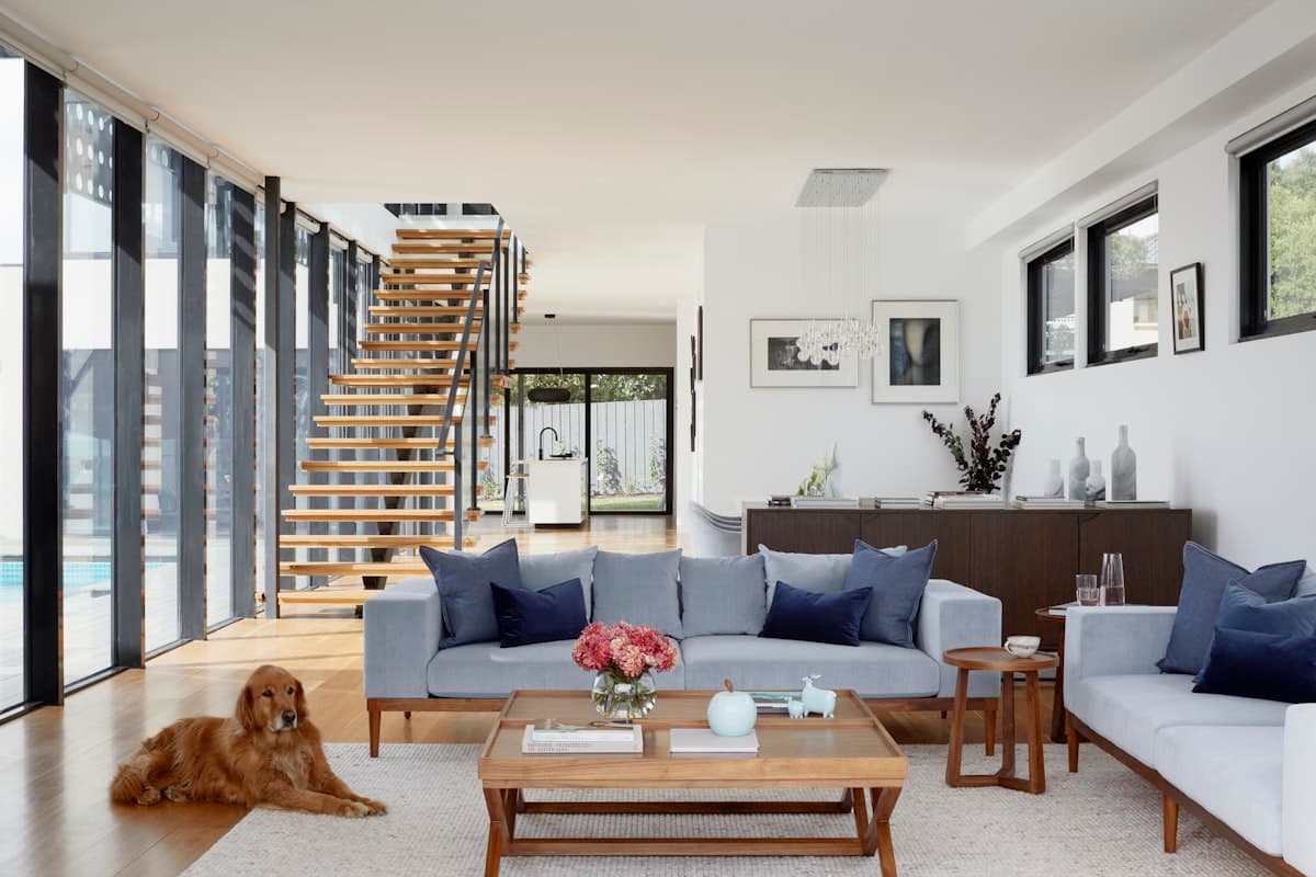 Great room interior with staircase, overlooking the pool
