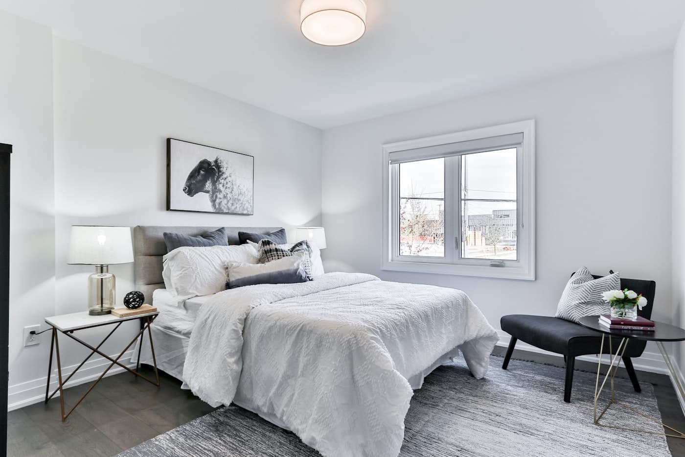 Guest bedroom with framed art and a window seat